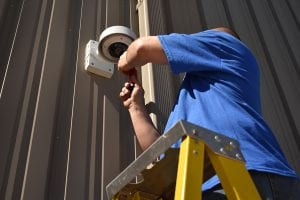 Professional expert installing alarm system